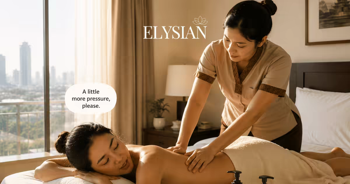 A guest asking a Thai therapist for more pressure during an in-room back massage in a Bangkok hotel room