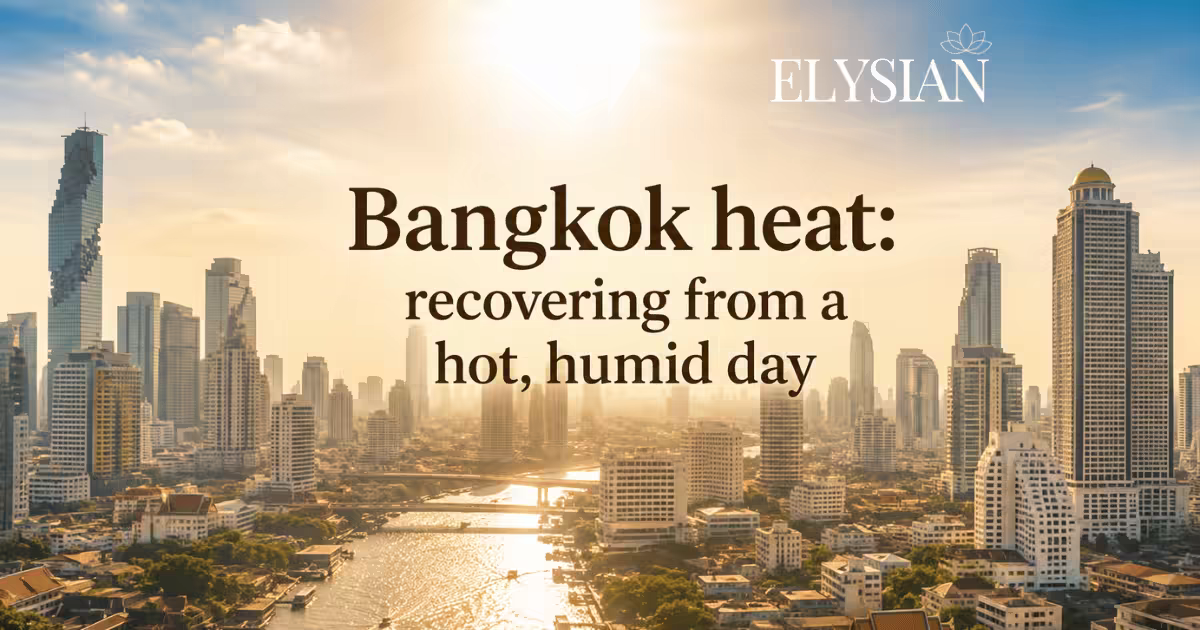 A hazy, sunlit Bangkok skyline over the river on a hot, humid day
