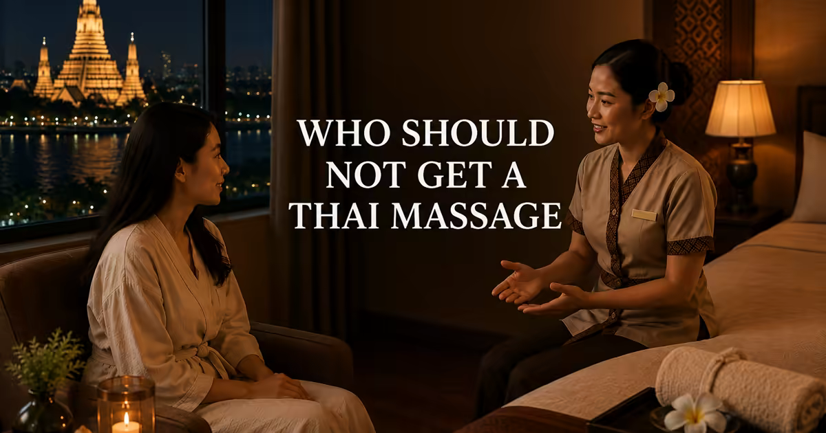 A Thai therapist talking with a guest in a Bangkok hotel room, discussing health before a massage, the lit temple behind
