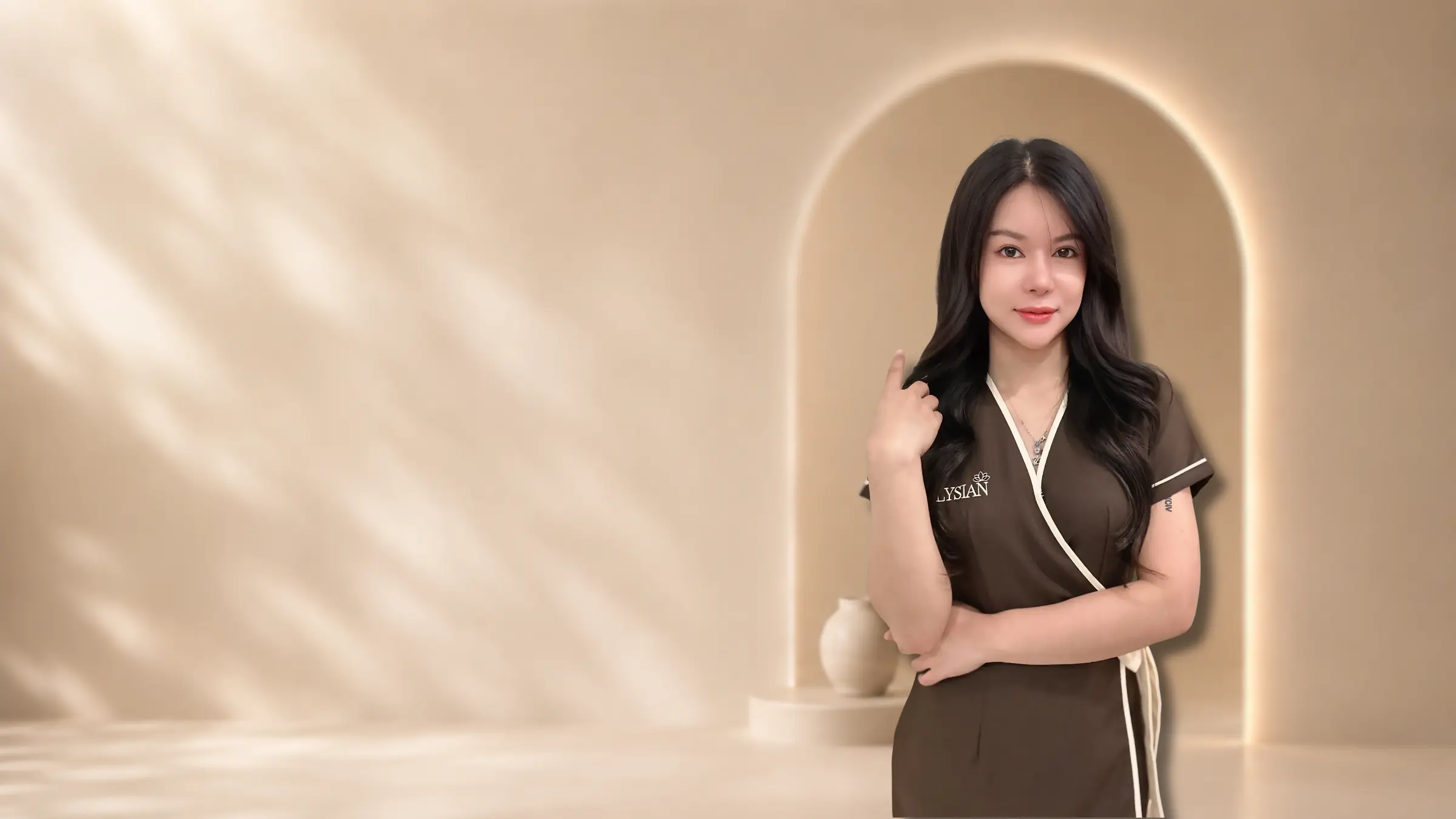 Licensed Thai therapist in Elysian uniform inside a cream-toned spa interior with arched doorway