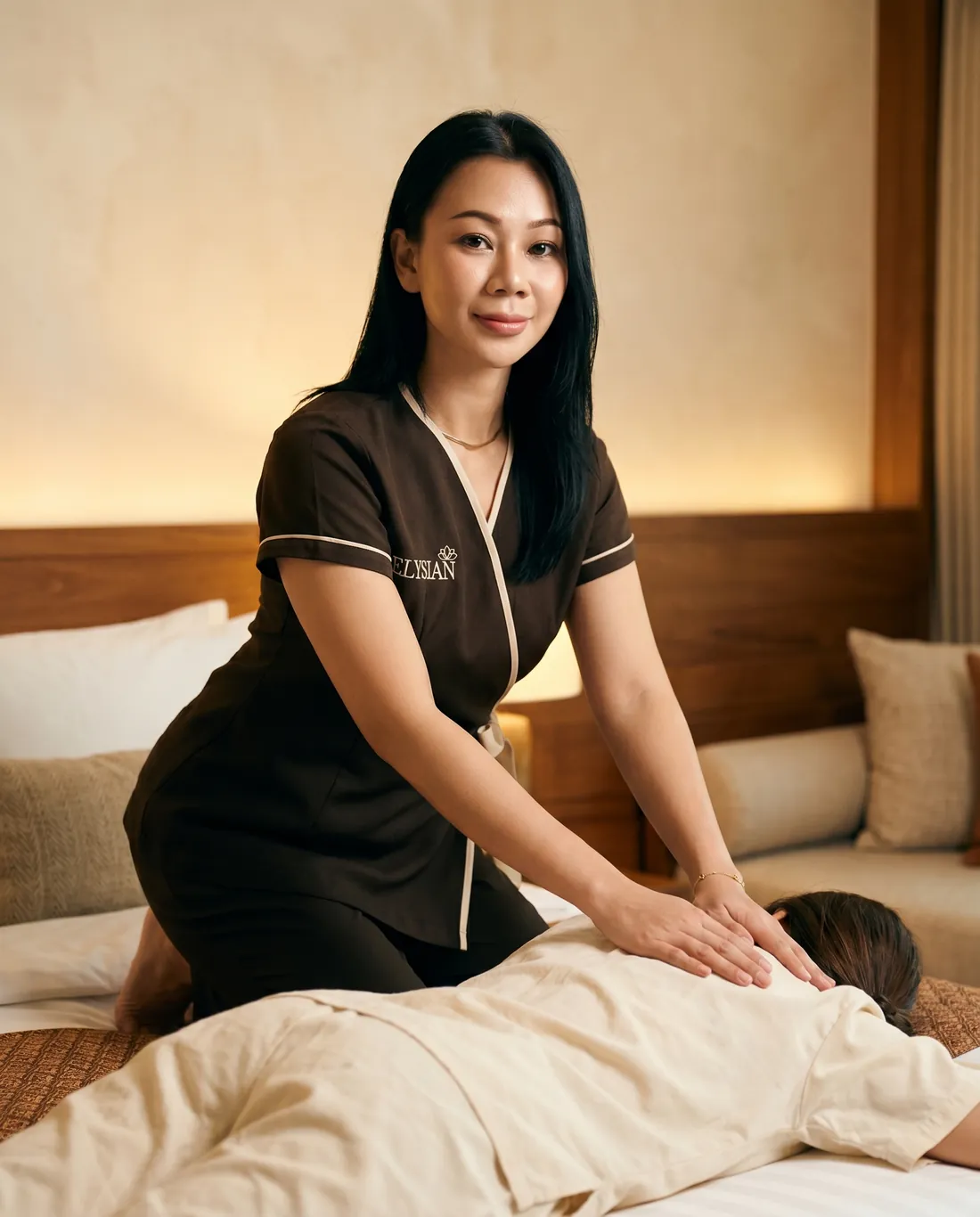 Licensed therapist performing traditional Thai massage in a Bangkok hotel room