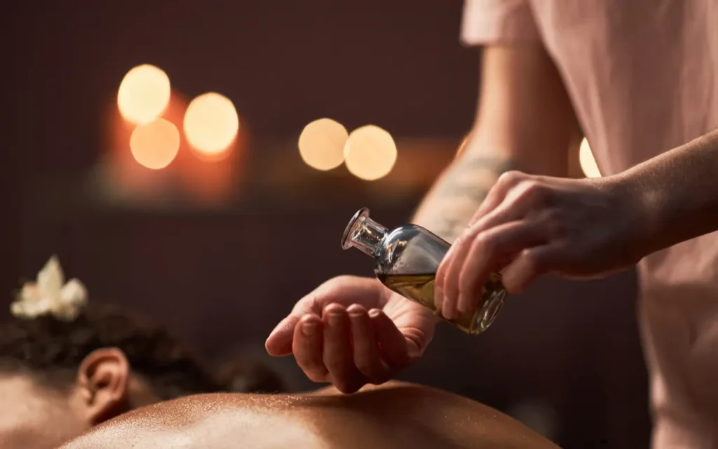 Professional therapist setting up an outcall massage in a Bangkok hotel room — Elysian Thai Spa.